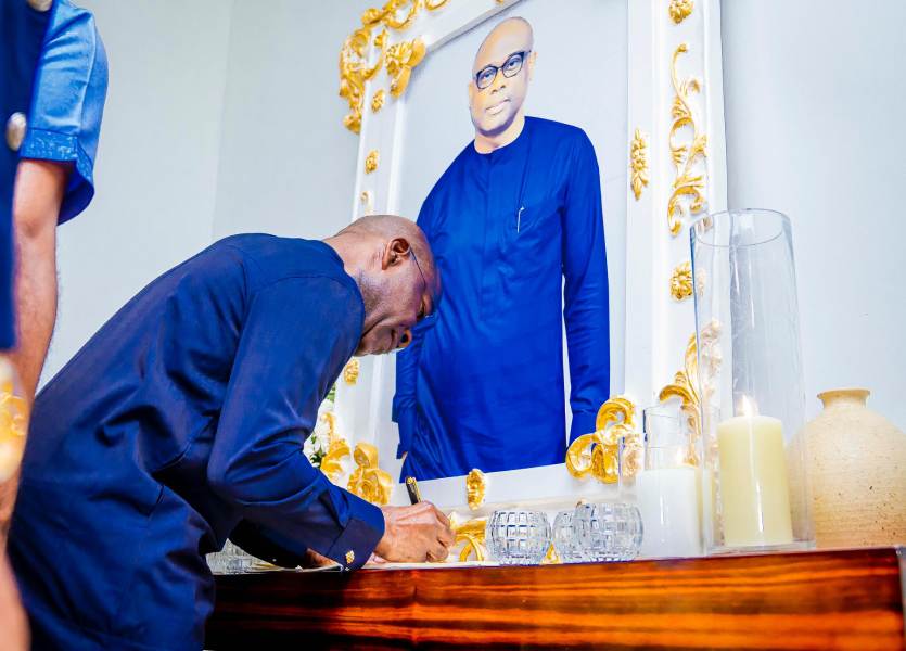 Governor Otti signing the condolence register.