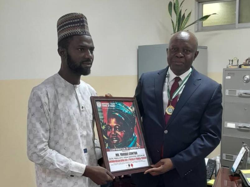 *  Yakubu Gontor, Director, Financial Services, Nigerian Communications Commission (NCC) being presented with Shield of Nigeria Northern Youth Award by Bilal Mohammed, Vice President, Northern Youth Council of Nigeria, in Abuja recently.