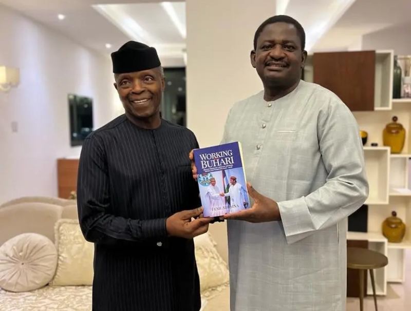 Professor Yemi Osinbajo, Nigeria's former Vice President (left) and Mr Femi Adesina, author of the book and former Presidential Spokesman (right) presenting his new book to Osinbajo.