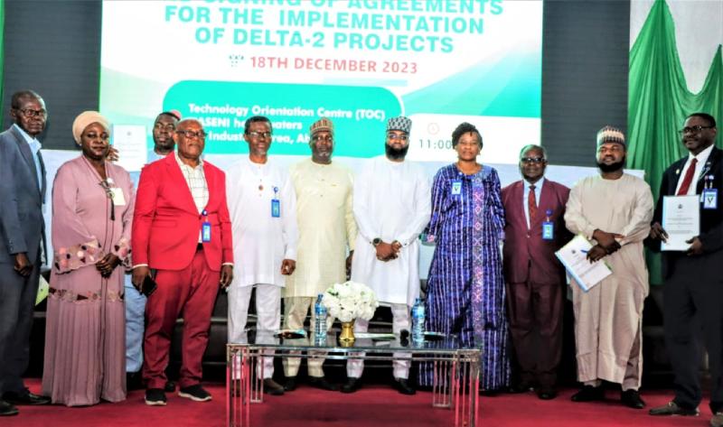 The Executive Vice Chairman and Chief Executive Officer of National Agency for Science and Engineering Infrastructure (NASENI), Mr. Khalil Suleiman Halilu (5th from left); the Chairman, Presidential Implementation Committee on Technology Transfer and Information Exchange, Dr. Mohammed Dahiru and  beneficiaries of the Delta-2 projects after the signing of implementation agreements at NASENI HQ in Abuja on Monday, December 18, 2023. 