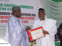 *  (L-R) National REC, INEC in charge of Bauchi, Borno and Yobe Mohammed Alkali shaking hands with Governor, Bala Mohammed while presenting him with a certificate of return of his re-election at State headquarters in Bauchi. 