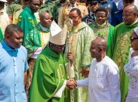 The Catholic Bishop of Umuahia Diocese, Most Rev. Michael Ukpong bids Governor Otti goodbye with a handshake after the service, while Deputy Governor Ikechukwu Emetu and wife of the Governor, Mrs. Priscilla Otti, watch keenly.